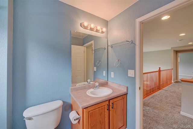 8545 Braun Loop, Arvada, CO 80005 - full bath with a textured wall, toilet, vanity, and recessed lighting