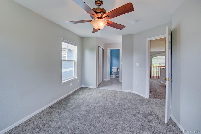 8545 Braun Loop, Arvada, CO 80005 - unfurnished bedroom featuring multiple windows, light colored carpet, and baseboards