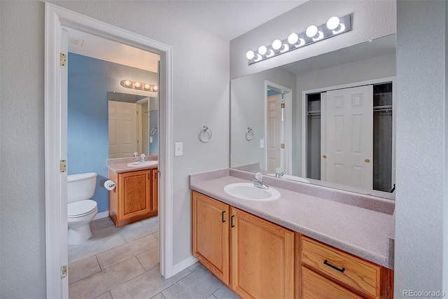 8545 Braun Loop, Arvada, CO 80005 - full bath featuring tile patterned floors, vanity, toilet, and baseboards