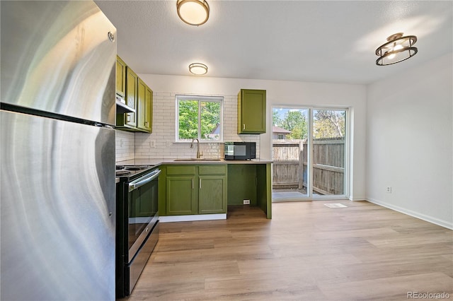 16251 E 17th Pl Unit C, Aurora, CO 80011 - kitchen with appliances with stainless steel finishes, green cabinets, a sink, and light wood-style flooring