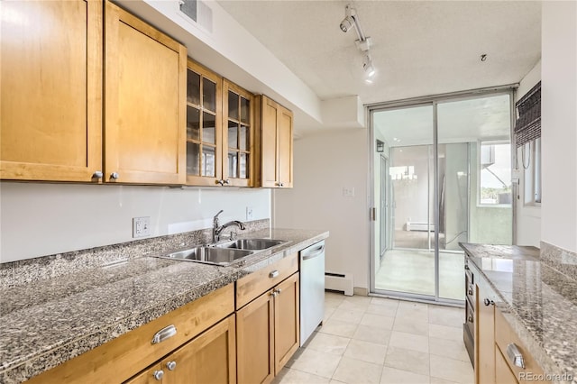 kitchen featuring a baseboard heating unit, stainless steel dishwasher, sink, light tile patterned floors, and rail lighting