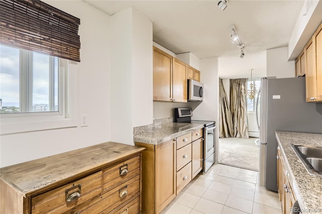 kitchen featuring a notable chandelier, light tile patterned flooring, appliances with stainless steel finishes, light brown cabinets, and rail lighting