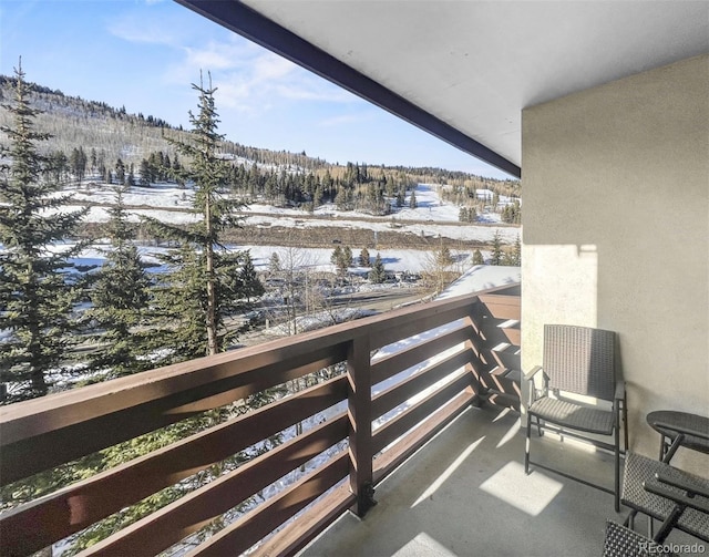 view of snow covered back of property