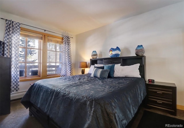 carpeted bedroom featuring a baseboard heating unit