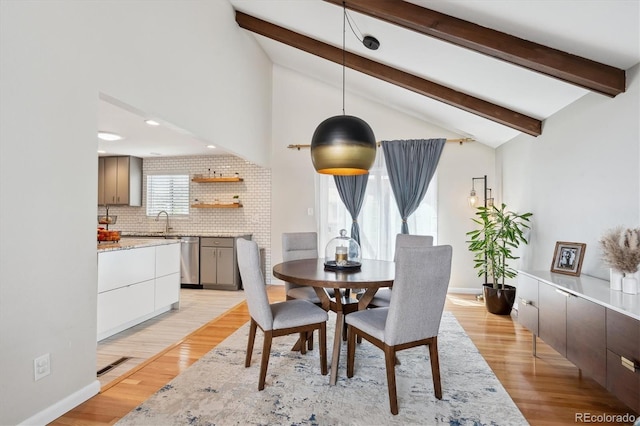 dining space featuring recessed lighting, baseboards, lofted ceiling with beams, and light wood finished floors