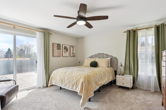 bedroom featuring carpet floors, access to outside, and a ceiling fan