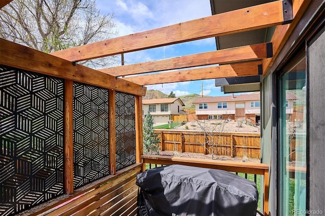 wooden deck with fence and area for grilling