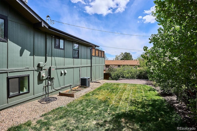 view of yard featuring central air condition unit and a vegetable garden