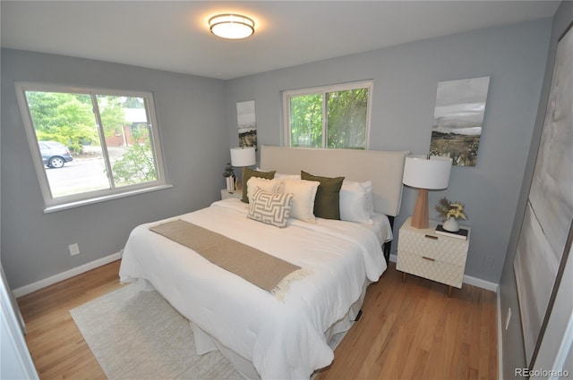 bedroom featuring light hardwood / wood-style floors and multiple windows