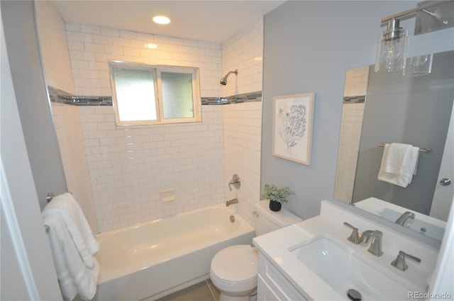 full bathroom with tiled shower / bath combo, vanity, and toilet