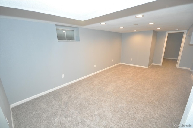 basement featuring light carpet