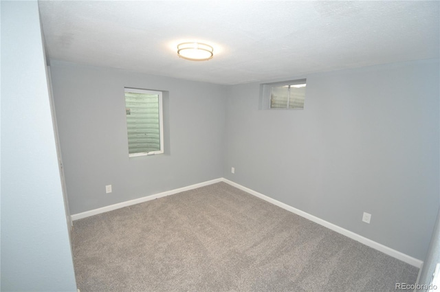 carpeted spare room featuring a textured ceiling