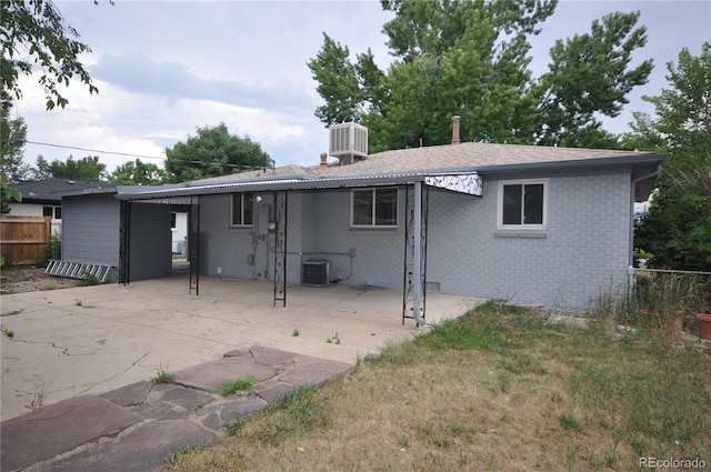 rear view of house featuring central AC