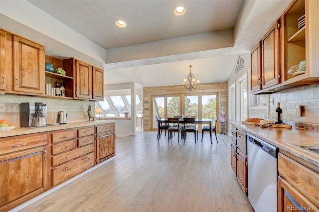 18045 Sunburst Dr, Monument, CO 80132 - kitchen featuring stainless steel dishwasher, brown cabinetry, light wood-style floors, decorative backsplash, and recessed lighting
