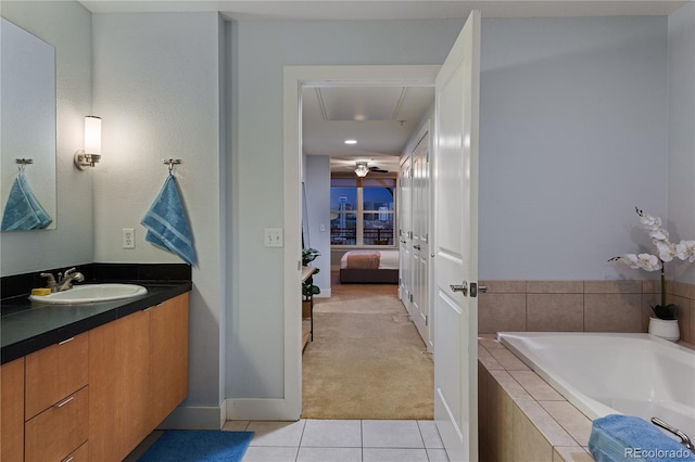 full bathroom with a relaxing tiled tub, ensuite bath, vanity, and tile patterned flooring