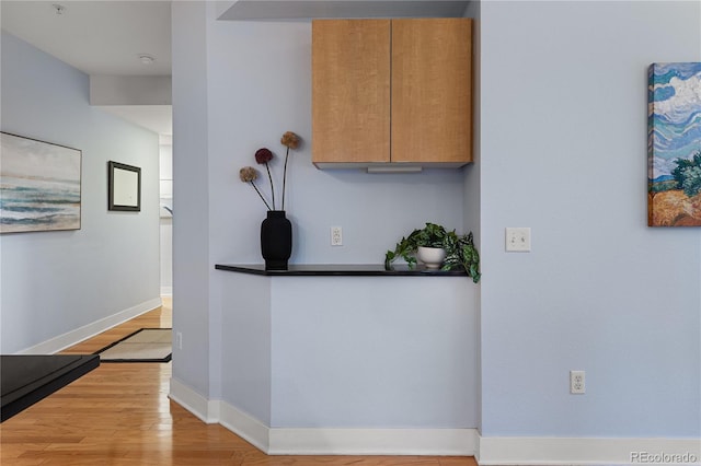 kitchen featuring wood finished floors and baseboards