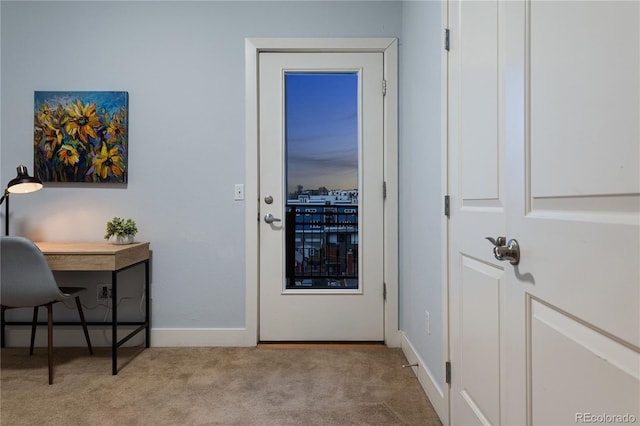 doorway with baseboards and carpet