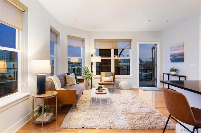 living area featuring light wood-type flooring and baseboards