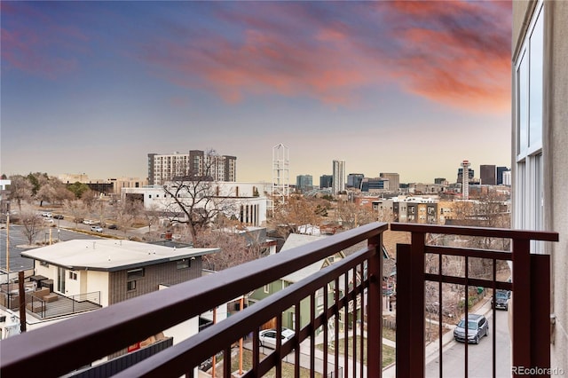 balcony at dusk with a view of city