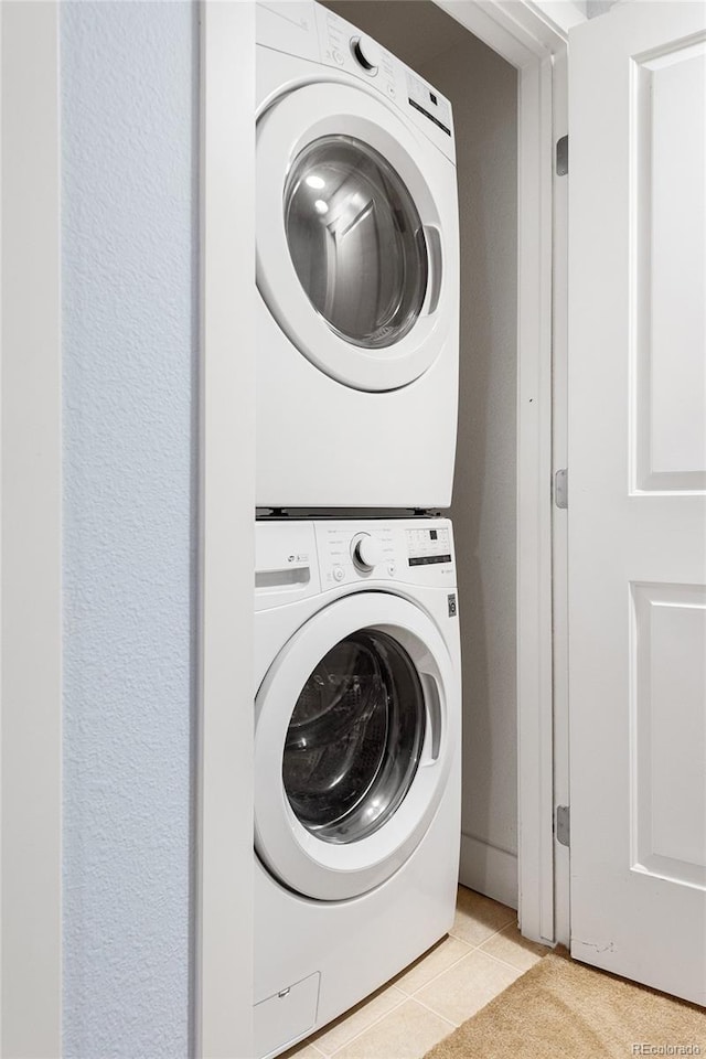2240 N Clay St Unit 501, Denver, CO 80211 - laundry room featuring stacked washer and clothes dryer and light tile patterned floors