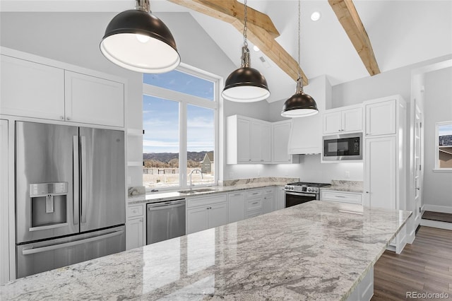 kitchen featuring white cabinets, sink, stainless steel appliances, and vaulted ceiling with beams