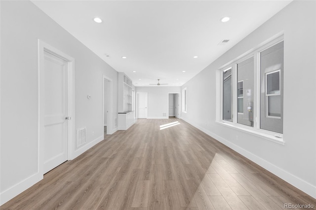 unfurnished living room with ceiling fan and light hardwood / wood-style flooring