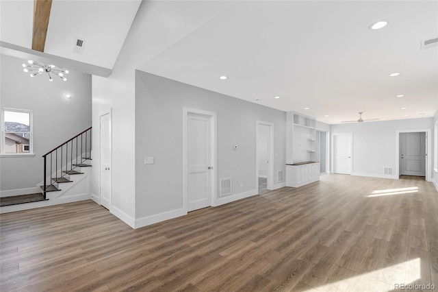 unfurnished living room with ceiling fan, wood-type flooring, and high vaulted ceiling