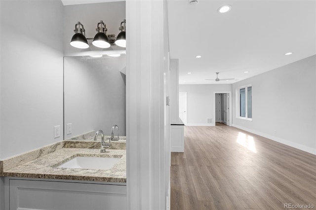 bathroom with ceiling fan, sink, and hardwood / wood-style flooring