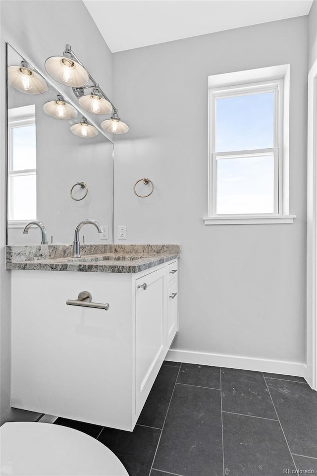 bathroom featuring toilet, vanity, and tile patterned flooring