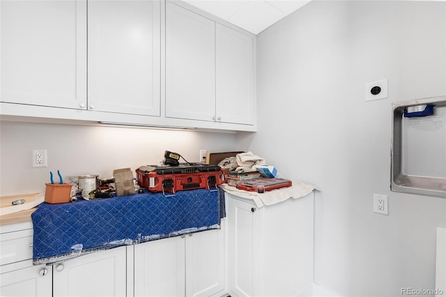 interior space featuring white cabinets and stone counters