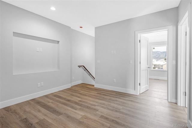 unfurnished room with light wood-type flooring