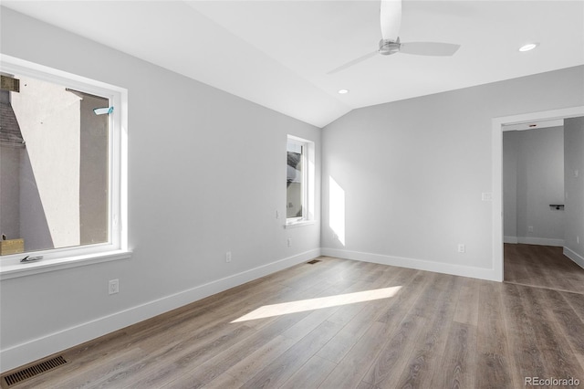 interior space with a healthy amount of sunlight, lofted ceiling, light hardwood / wood-style floors, and ceiling fan