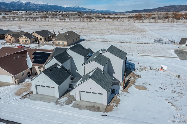 snowy aerial view with a mountain view