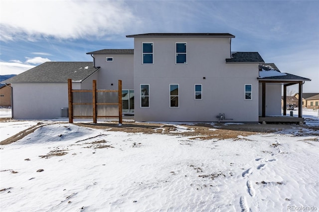 view of snow covered rear of property