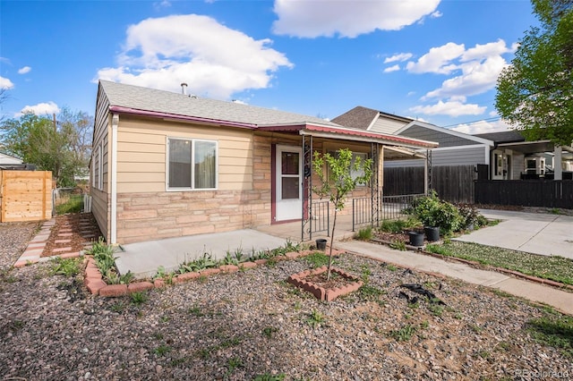 1910 S King St, Denver, CO 80219 - view of front of house with stone siding and roof with shingles