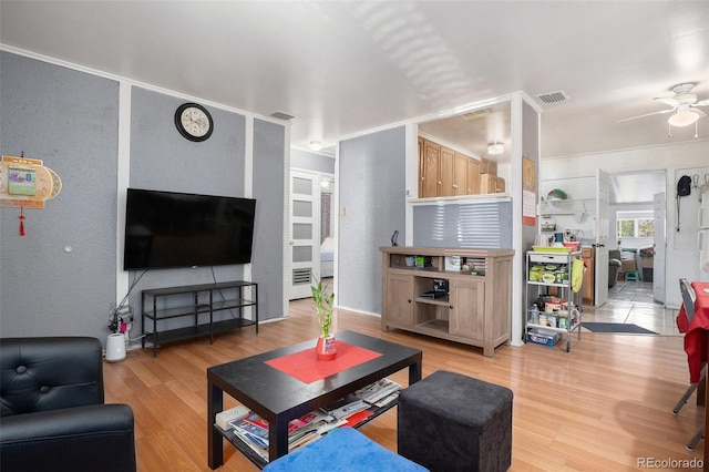 1910 S King St, Denver, CO 80219 - living room featuring light wood-style flooring, a ceiling fan, and a textured wall