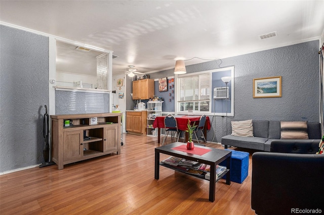 1910 S King St, Denver, CO 80219 - living room featuring a textured wall, light wood-style floors, a ceiling fan, and crown molding