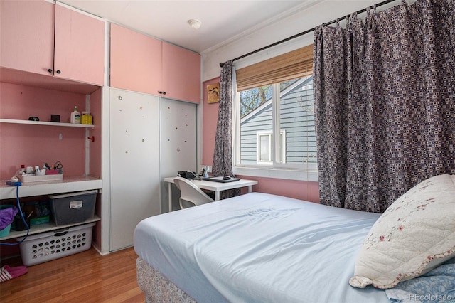 1910 S King St, Denver, CO 80219 - bedroom with light wood-style flooring and crown molding