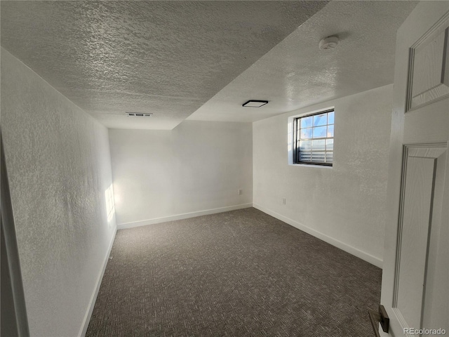 carpeted spare room featuring a textured ceiling