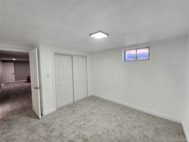 basement with carpet and a textured ceiling