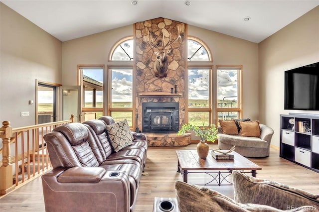 15125 Spring Valley Rd, Larkspur, CO 80118 - living area with plenty of natural light, a wood stove, light wood-style floors, and high vaulted ceiling
