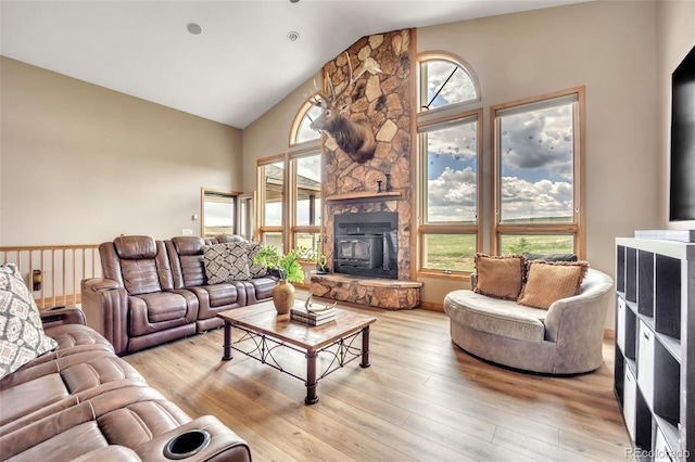 15125 Spring Valley Rd, Larkspur, CO 80118 - living area featuring a wood stove, high vaulted ceiling, and light wood-style flooring