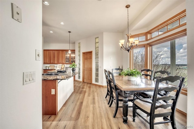 15125 Spring Valley Rd, Larkspur, CO 80118 - dining area with light wood-type flooring, a chandelier, recessed lighting, and baseboards