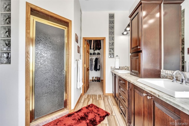 15125 Spring Valley Rd, Larkspur, CO 80118 - bathroom with double vanity, a walk in closet, and a stall shower