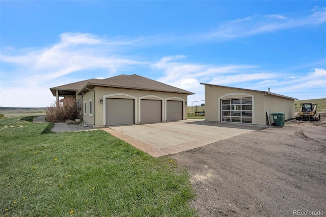 15125 Spring Valley Rd, Larkspur, CO 80118 - view of side of home featuring stucco siding, a yard, driveway, and an attached garage