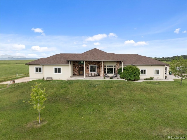 15125 Spring Valley Rd, Larkspur, CO 80118 - rear view of house with a yard, stucco siding, a patio area, and roof with shingles