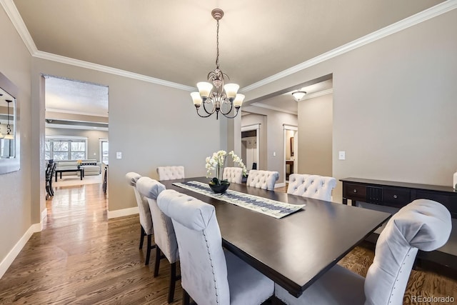 dining space featuring crown molding, dark hardwood / wood-style floors, and a chandelier