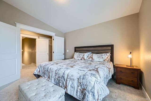 bedroom with light colored carpet and vaulted ceiling