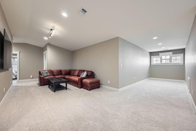 carpeted living room featuring vaulted ceiling