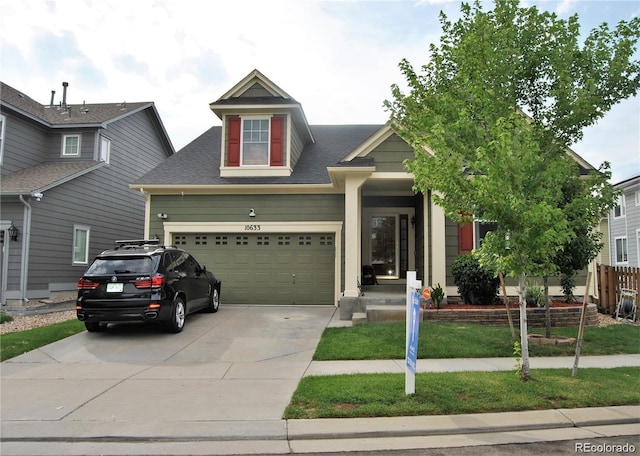 view of front of house featuring a front yard and a garage